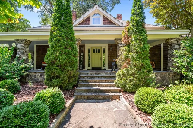 a front view of a house with a garden