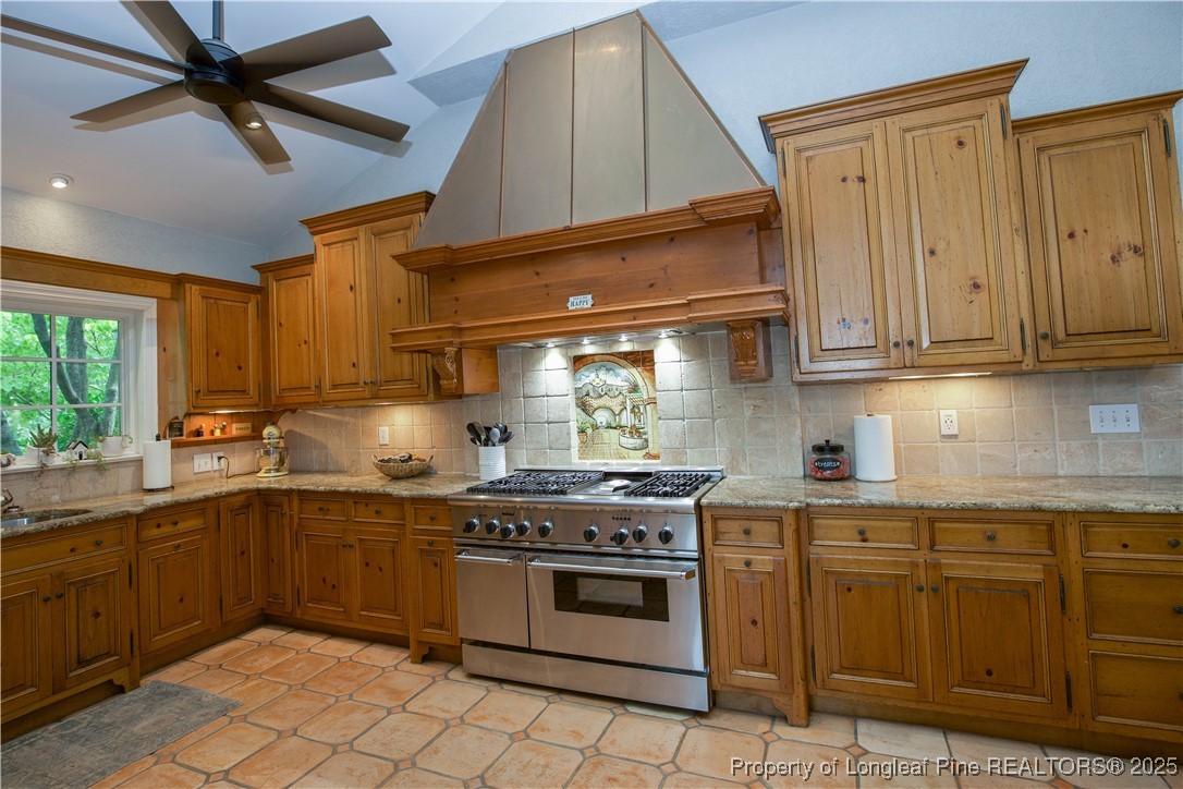 200 Cameron Avenue Vass, NC 28394 - Photo 12 of 50 a kitchen with a stove sink and cabinets
