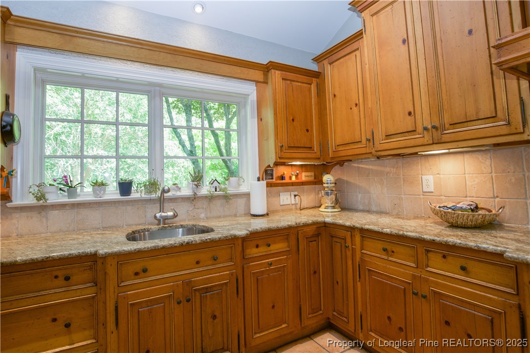 200 Cameron Avenue Vass, NC 28394 - Photo 14 of 50 a kitchen with granite countertop cabinets stainless steel appliances a sink and window