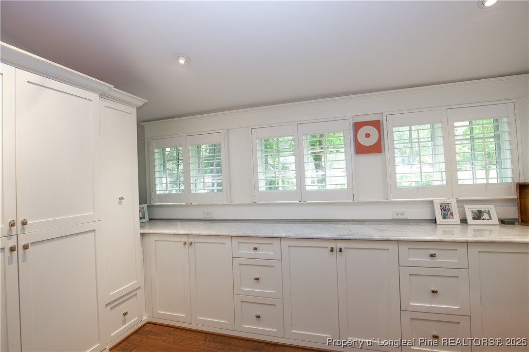 200 Cameron Avenue Vass, NC 28394 - Photo 21 of 50 a kitchen with granite countertop white cabinets and sink
