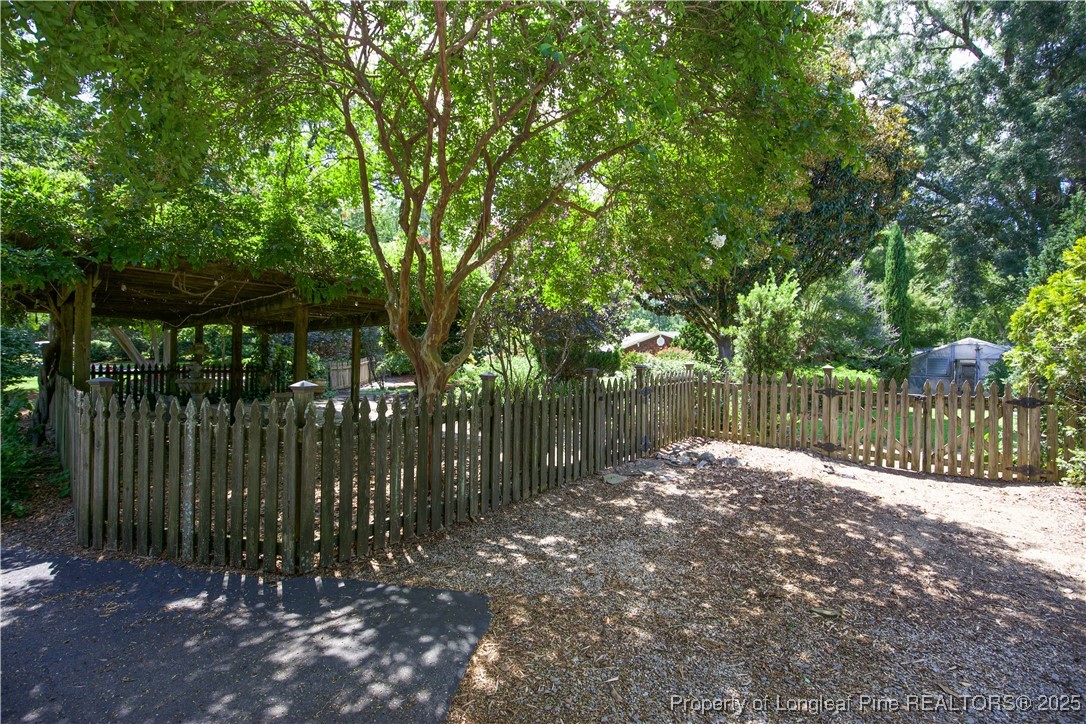 200 Cameron Avenue Vass, NC 28394 - Photo 32 of 50 a backyard of a house with lots of green space