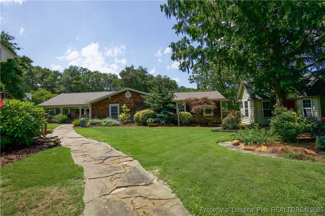 200 Cameron Avenue Vass, NC 28394 - Photo 38 of 50 a front view of a house with garden