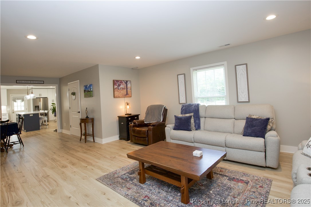 200 Cameron Avenue Vass, NC 28394 - Photo 45 of 50 a living room with furniture a table and a window