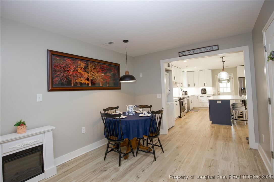200 Cameron Avenue Vass, NC 28394 - Photo 46 of 50 a view of a dining room with furniture and wooden floor