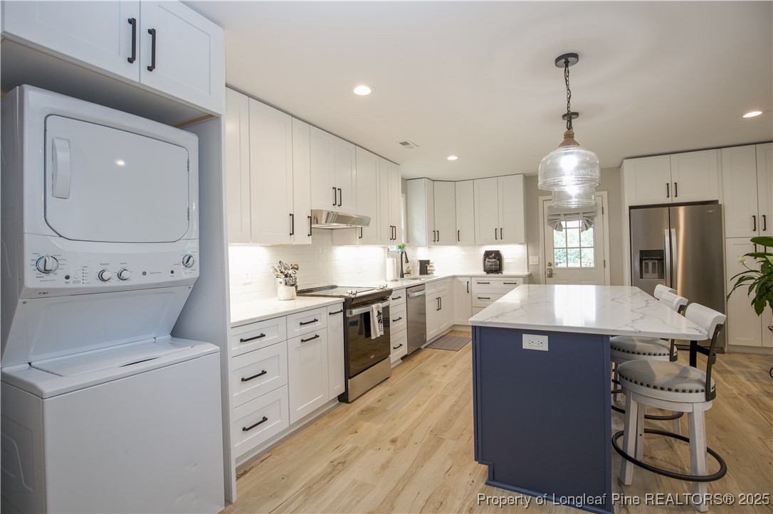 200 Cameron Avenue Vass, NC 28394 - Photo 47 of 50 a kitchen with stainless steel appliances kitchen island granite countertop a sink stove and refrigerator