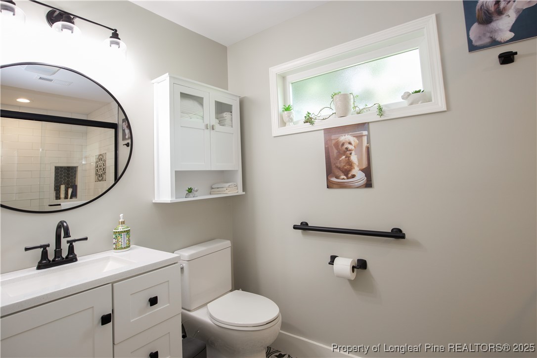 200 Cameron Avenue Vass, NC 28394 - Photo 50 of 50 a bathroom with a toilet a sink and mirror