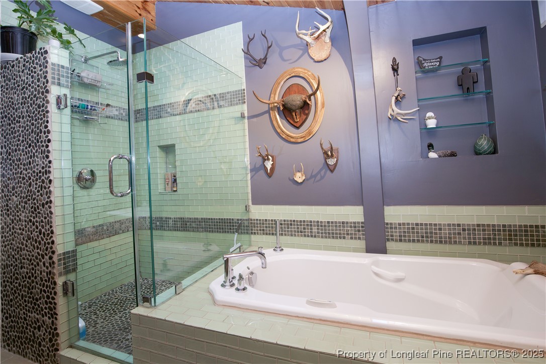 200 Cameron Avenue Vass, NC 28394 - Photo 9 of 50 a bathroom with a bathtub and a shower