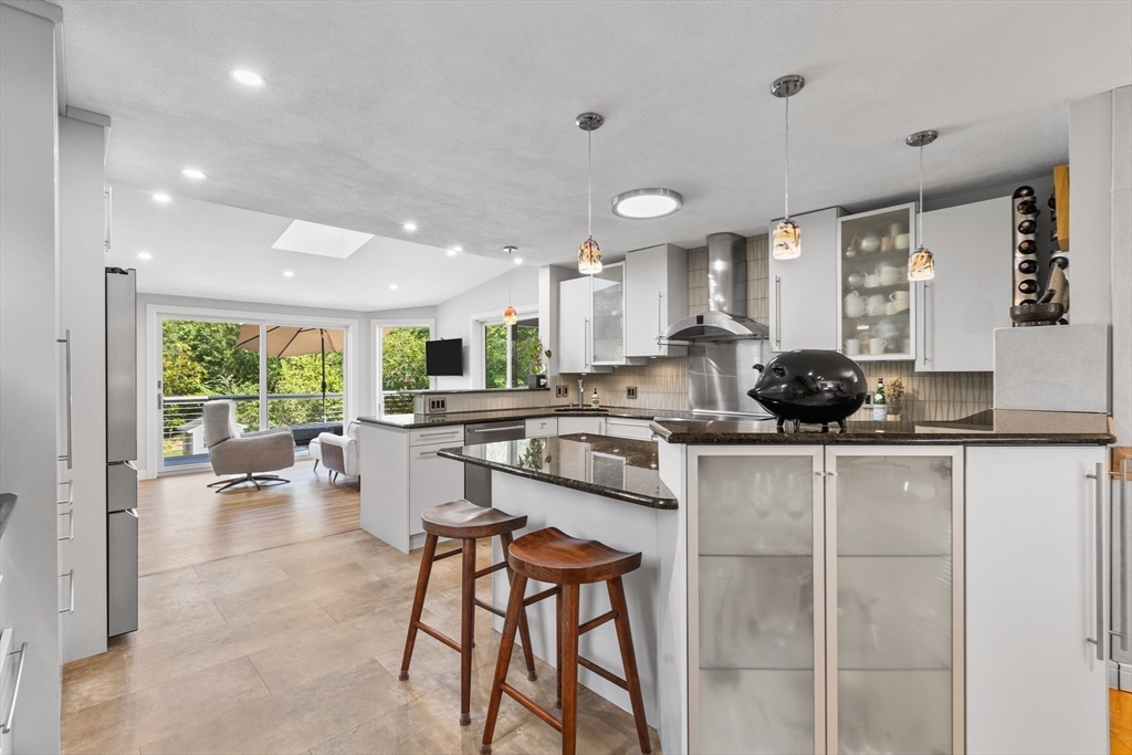 409 Haverhill Street Reading, MA 01867 - Photo 11 of 42 a kitchen with a table chairs stove and cabinets
