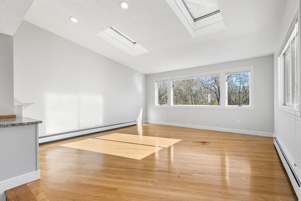 409 Haverhill Street Reading, MA 01867 - Photo 34 of 42 a view of empty room with wooden floor and fan