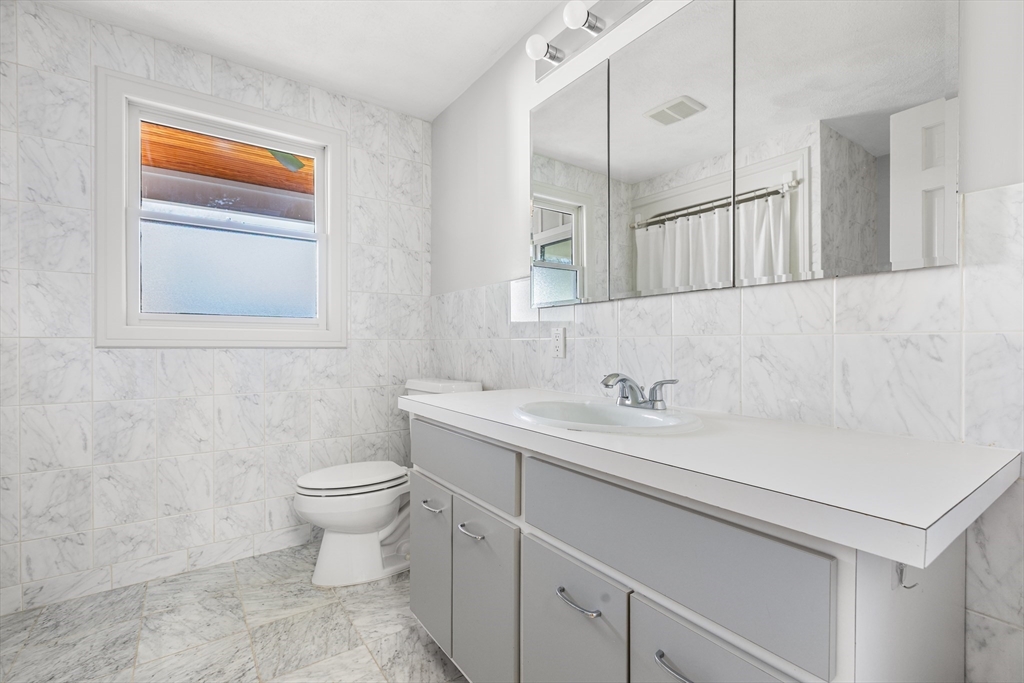 409 Haverhill Street Reading, MA 01867 - Photo 38 of 42 a bathroom with a sink and a toilet