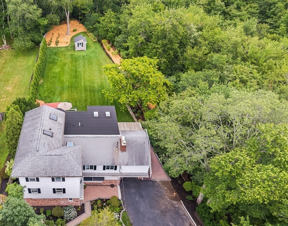 409 Haverhill Street Reading, MA 01867 - Photo 41 of 42 an aerial view of a house with a yard and large trees