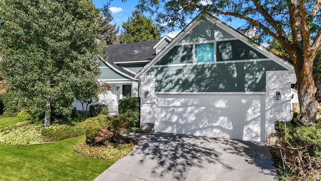 View of front of house with driveway and a front lawn
