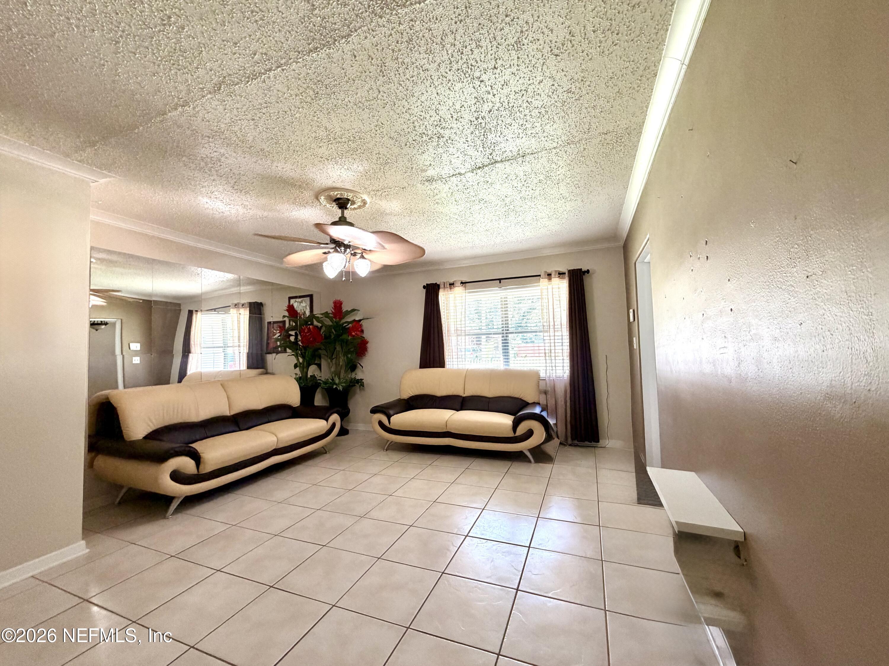 4127 Springwood Road Jacksonville, FL 32207 - Photo 7 of 63 a living room with furniture and a chandelier
