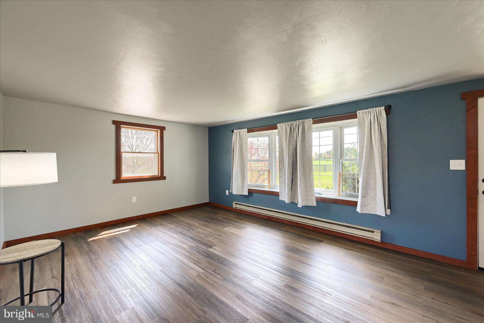 1144 Centennial Road New Oxford, PA 17350 - Photo 11 of 40 a view of an empty room with wooden floor and a window