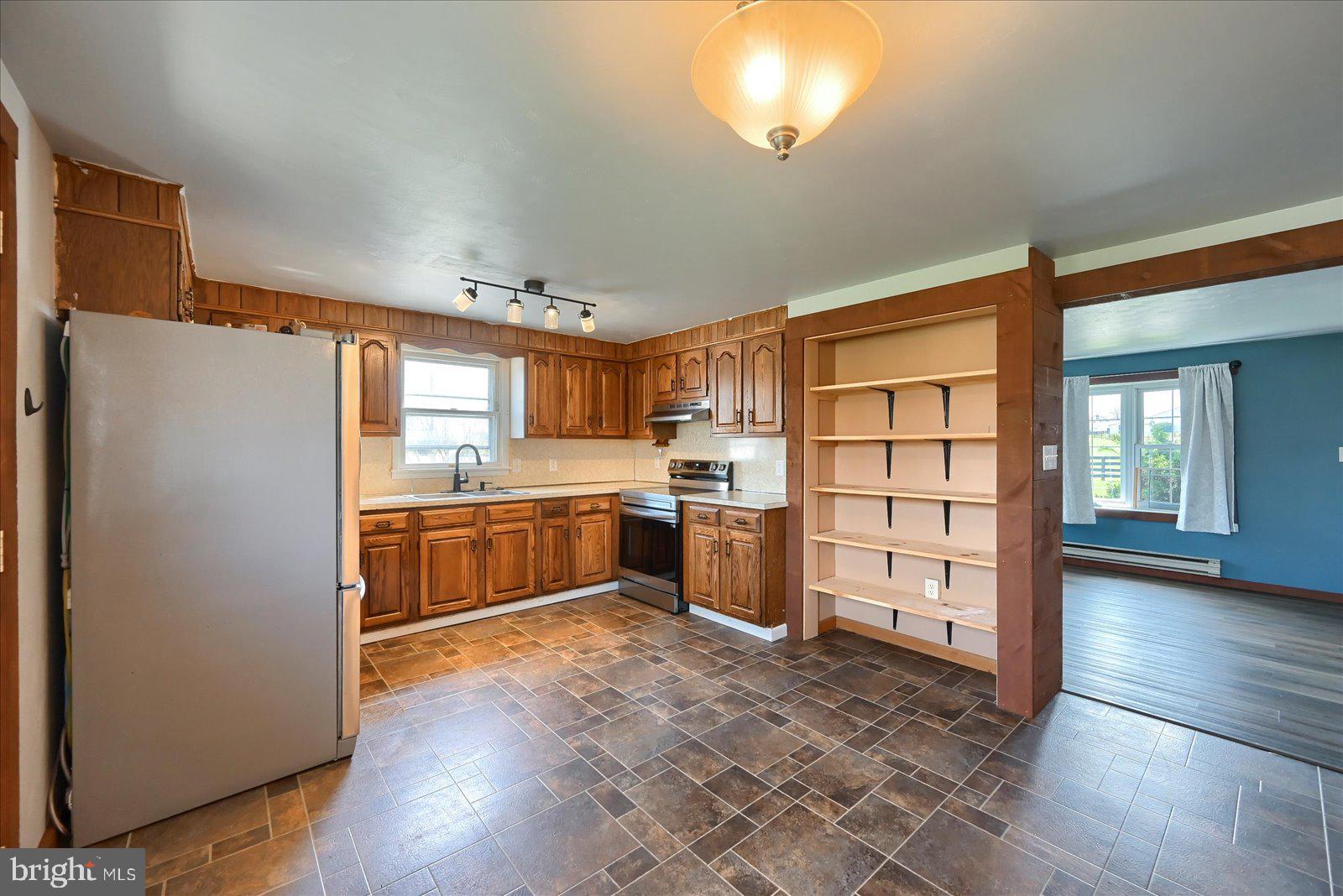 1144 Centennial Road New Oxford, PA 17350 - Photo 13 of 40 a kitchen with stainless steel appliances a refrigerator and a stove top oven