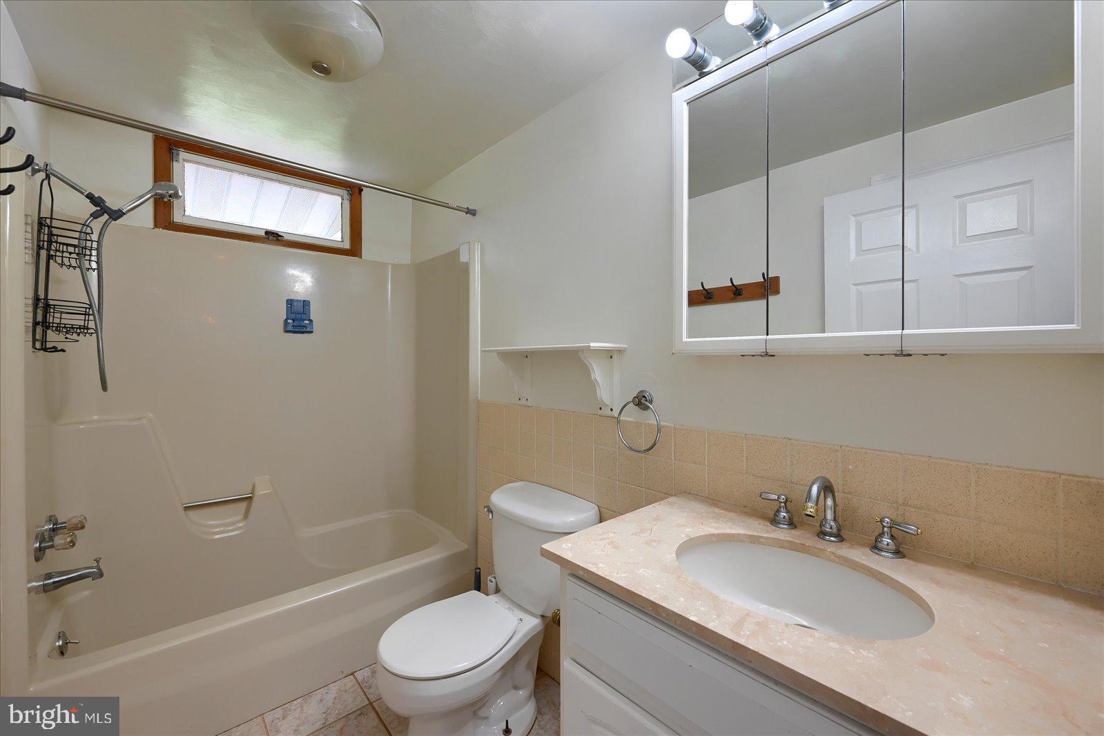 1144 Centennial Road New Oxford, PA 17350 - Photo 18 of 40 a bathroom with a granite countertop sink a toilet and shower