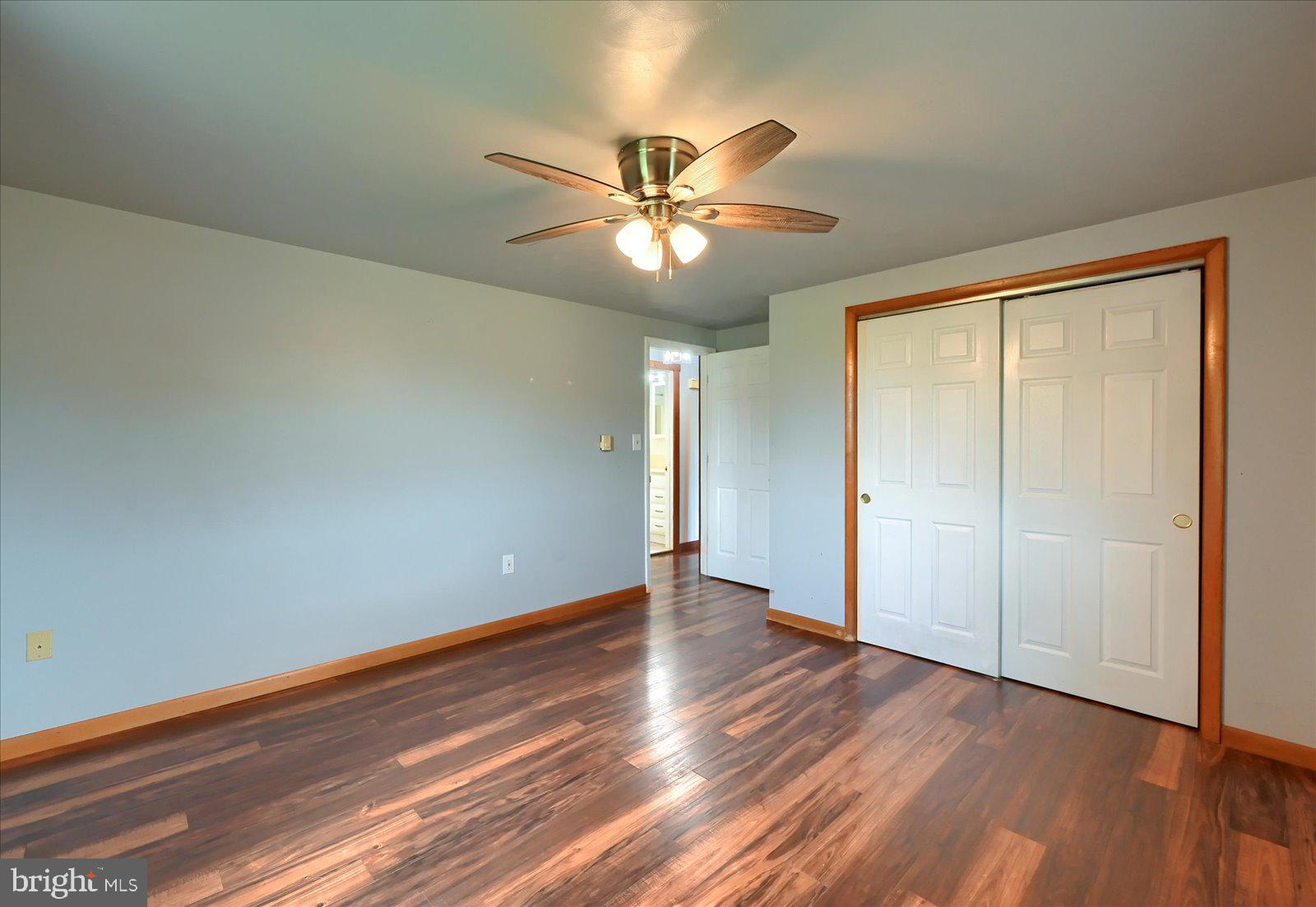 1144 Centennial Road New Oxford, PA 17350 - Photo 22 of 40 a view of an empty room with window and wooden floor