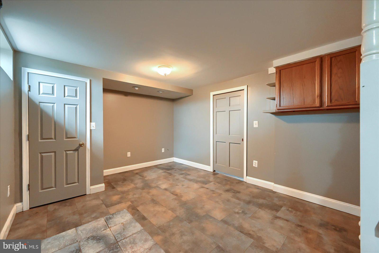 1144 Centennial Road New Oxford, PA 17350 - Photo 25 of 40 an empty room with wooden floor and cabinet
