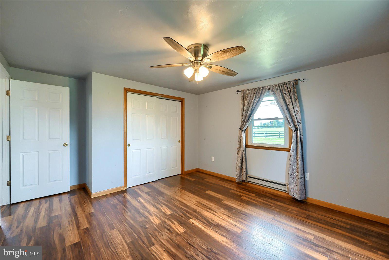 1144 Centennial Road New Oxford, PA 17350 - Photo 27 of 40 a view of an empty room with window and wooden floor