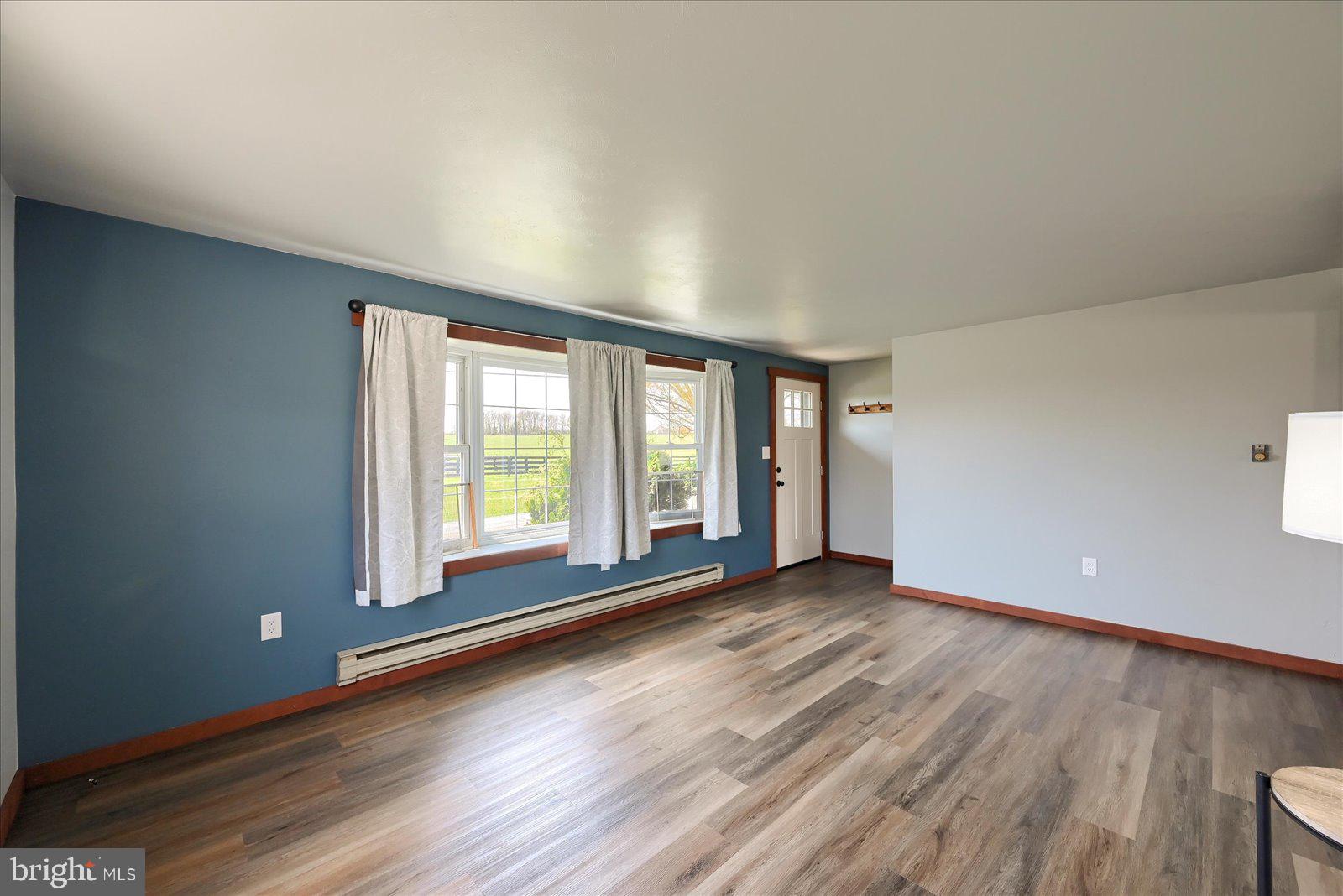 1144 Centennial Road New Oxford, PA 17350 - Photo 10 of 40 a view of an empty room with wooden floor and a window