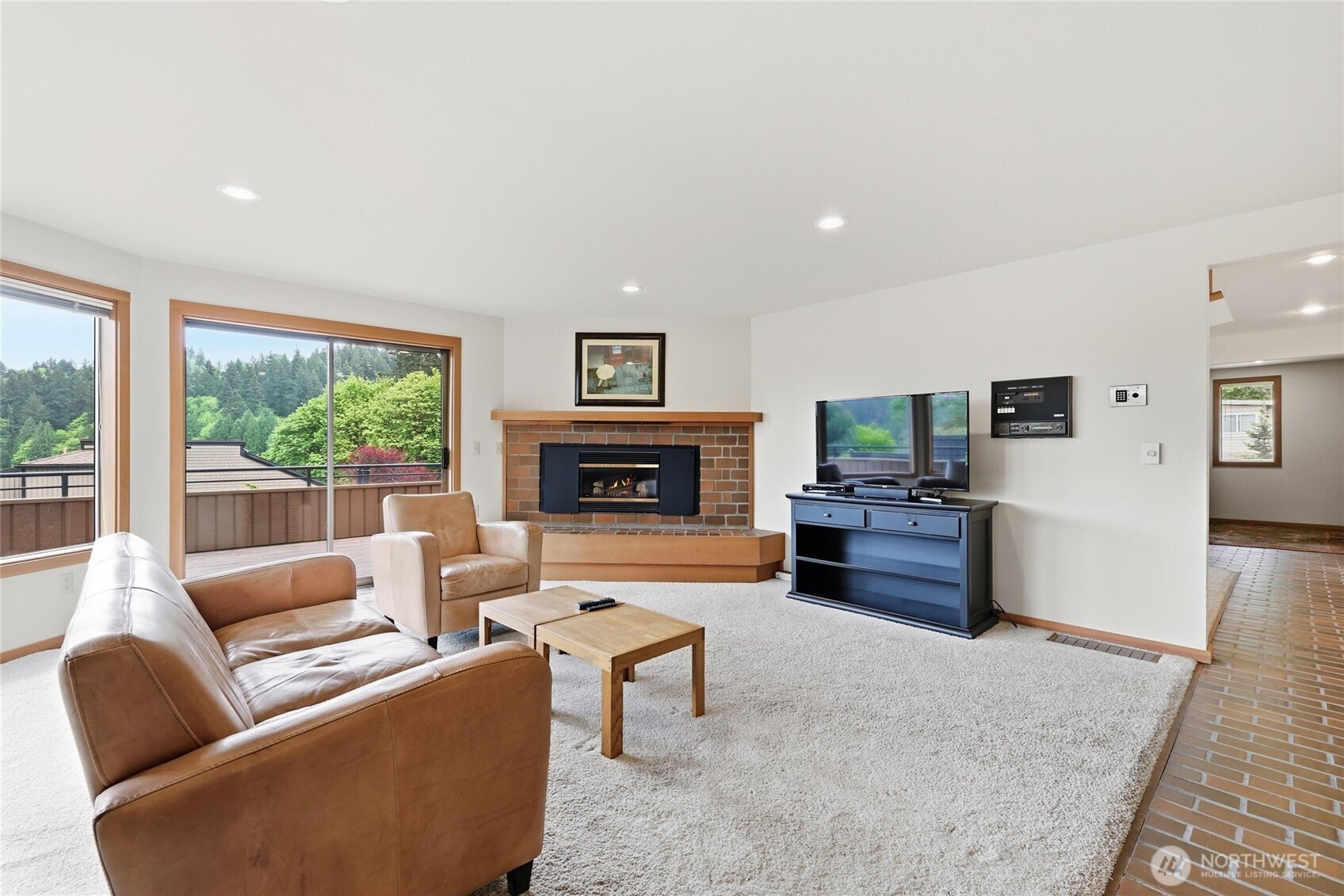 9520 Odin Way Bothell, WA 98011 - Photo 8 of 40 a living room with furniture flat screen tv and a fireplace