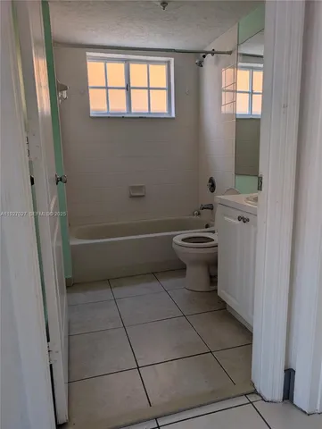 a bathroom with a sink a toilet and a window