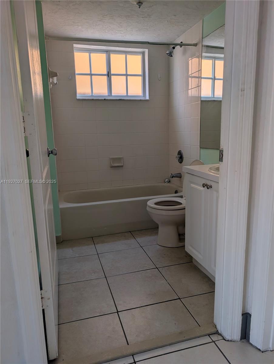 2485 West 76th Street, Unit 109 Hialeah, FL 33016 - Photo 11 of 15 a bathroom with a sink a toilet and a window
