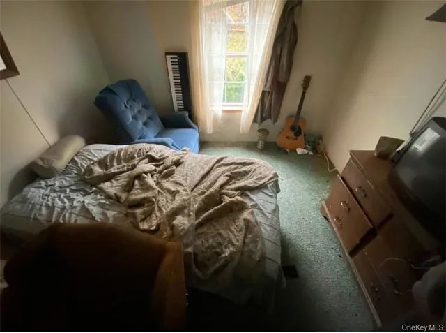 a bedroom with a bed lamp and a window