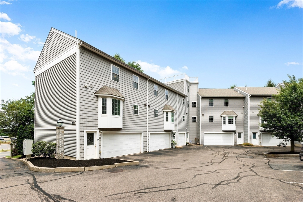 2 Ricciuti Drive, Unit 9 Quincy, MA 02169 - Photo 2 of 40 a front view of a house with a yard
