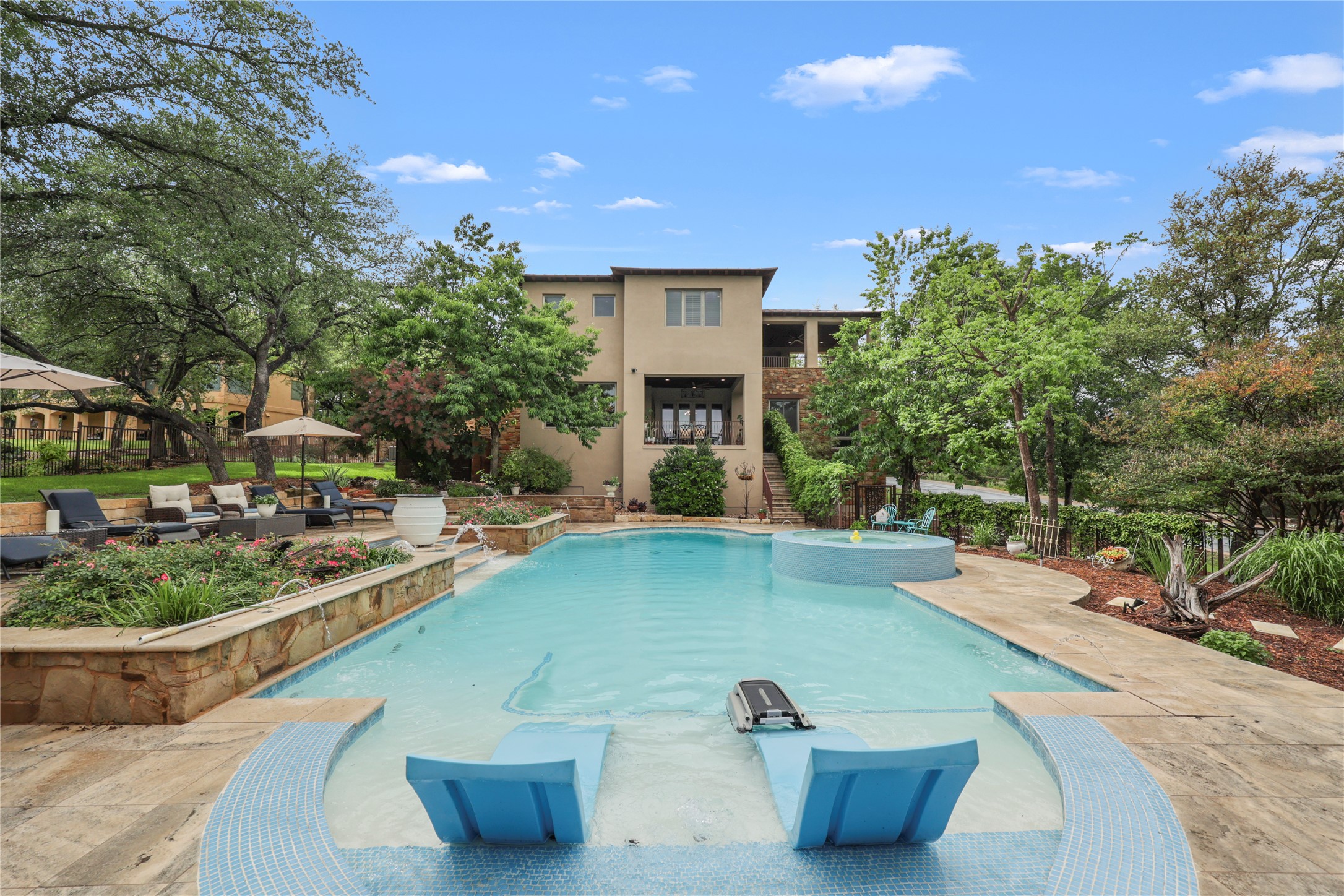 17501 Navigation Lane Lago Vista, TX 78645 - Photo 1 of 40 The property features luscious landscaping, a heated swimming pool, heated spa, and numerous seating and entertaining areas.