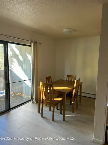 a view of a dining room with furniture and a window