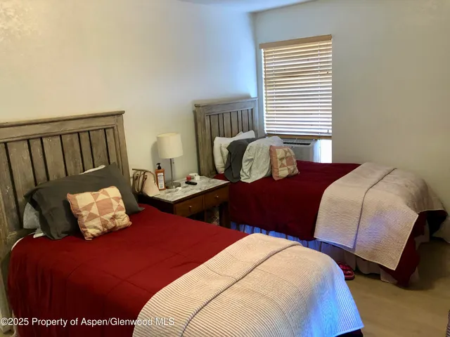 a bedroom with two beds and a couch