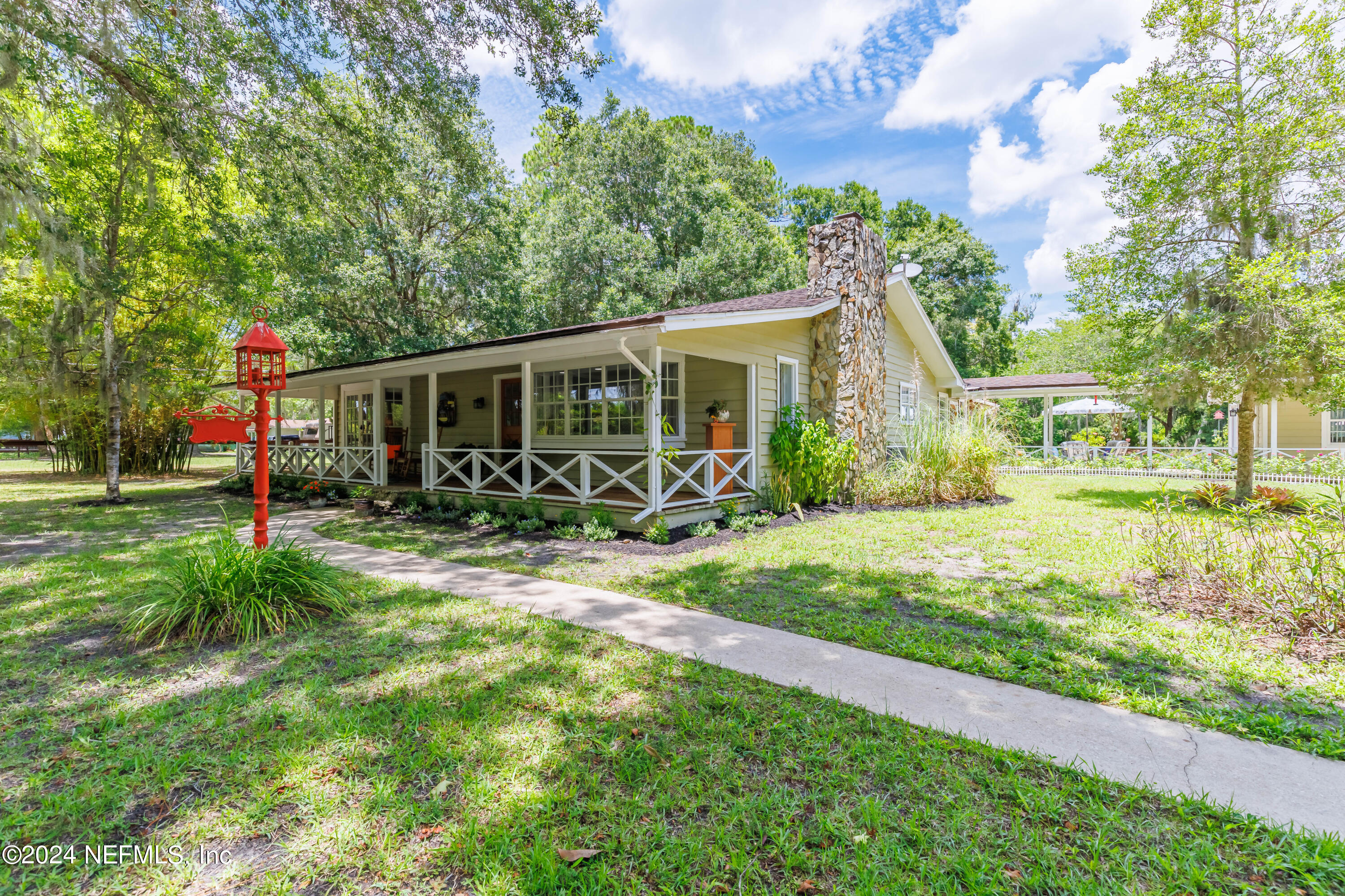 6070 Datil Pepper Road St. Augustine, FL 32086 - Photo 11 of 73 a view of a house with backyard and a tree