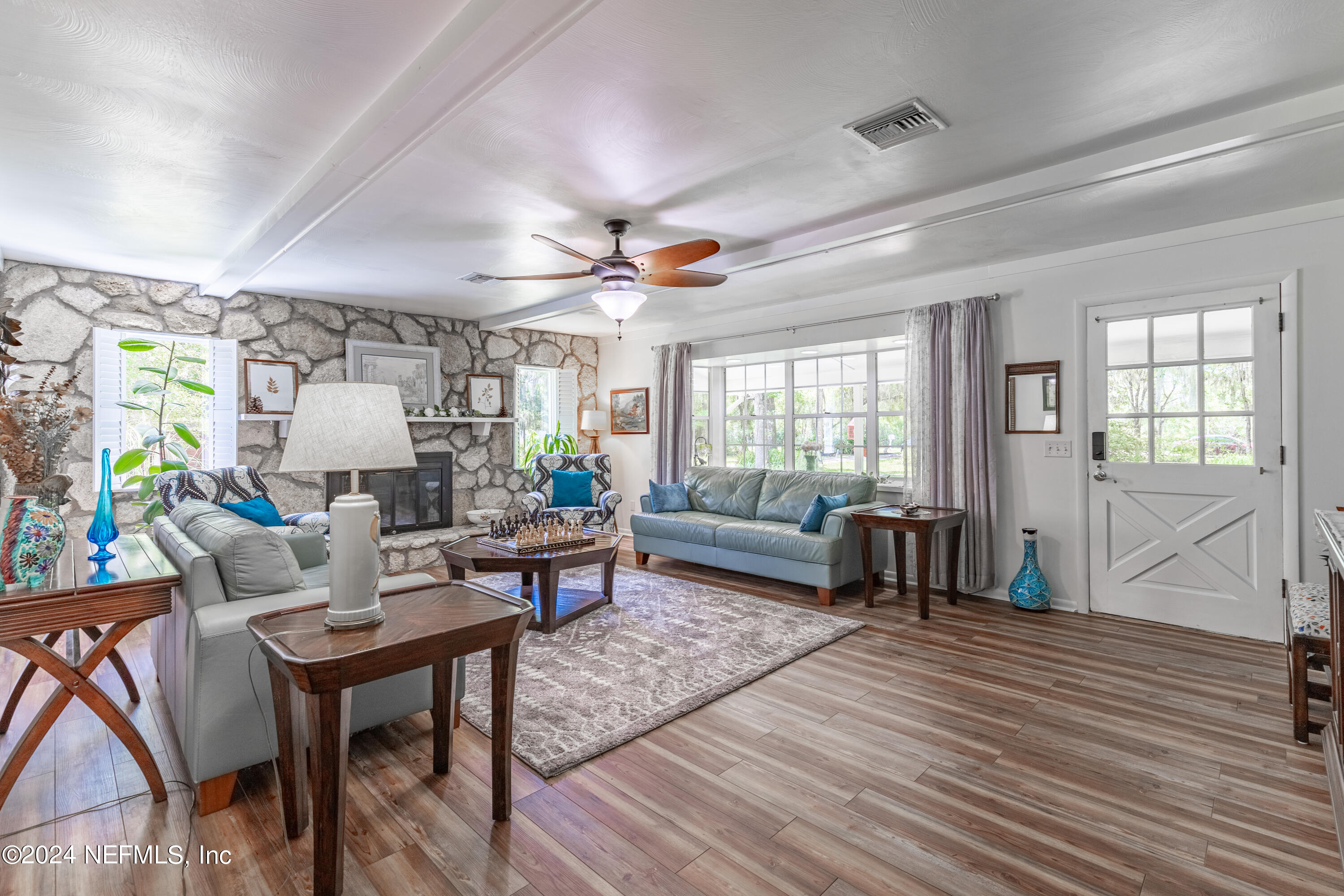6070 Datil Pepper Road St. Augustine, FL 32086 - Photo 25 of 73 a living room with furniture and a wooden floor