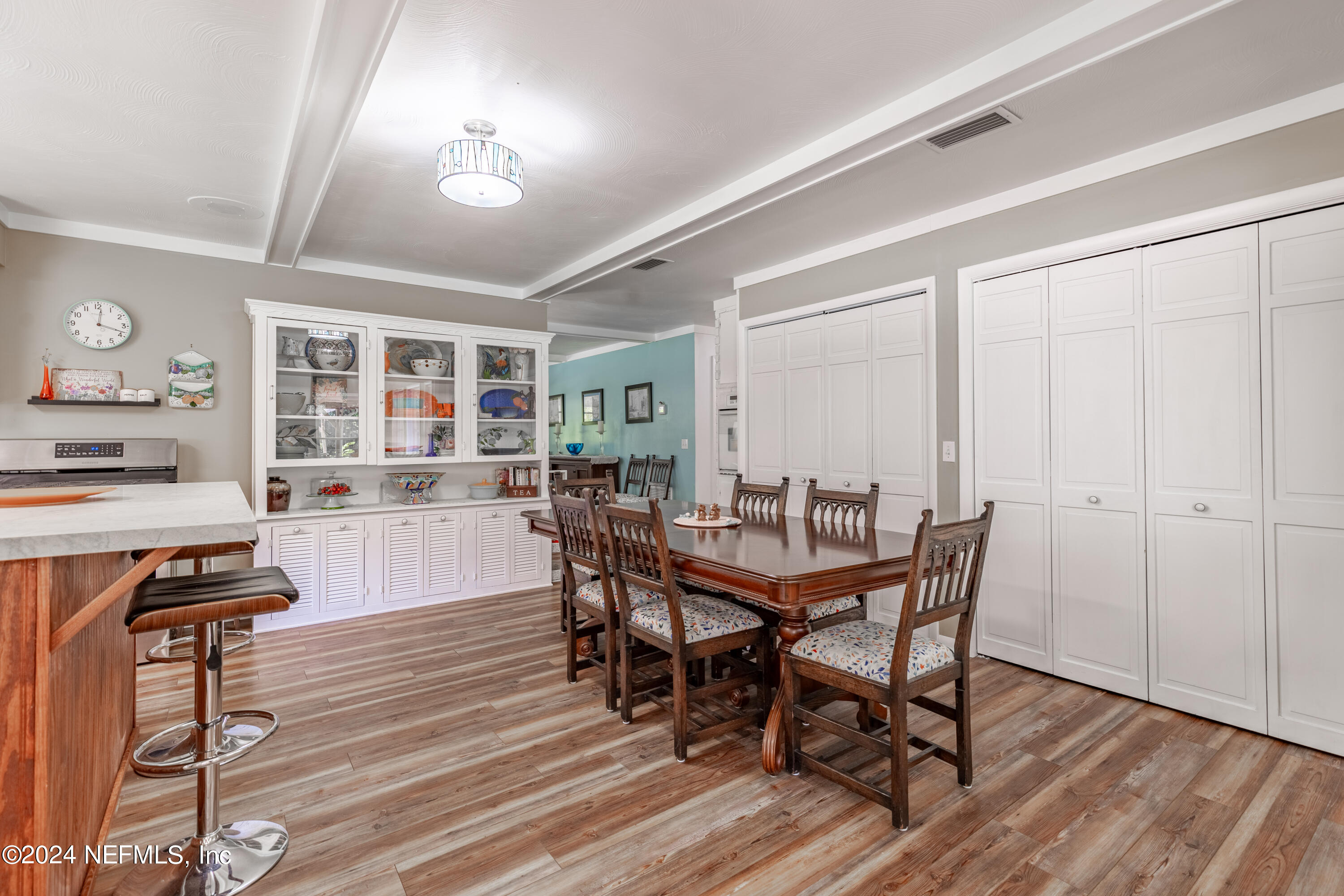6070 Datil Pepper Road St. Augustine, FL 32086 - Photo 30 of 73 a view of a dining room with furniture and wooden floor
