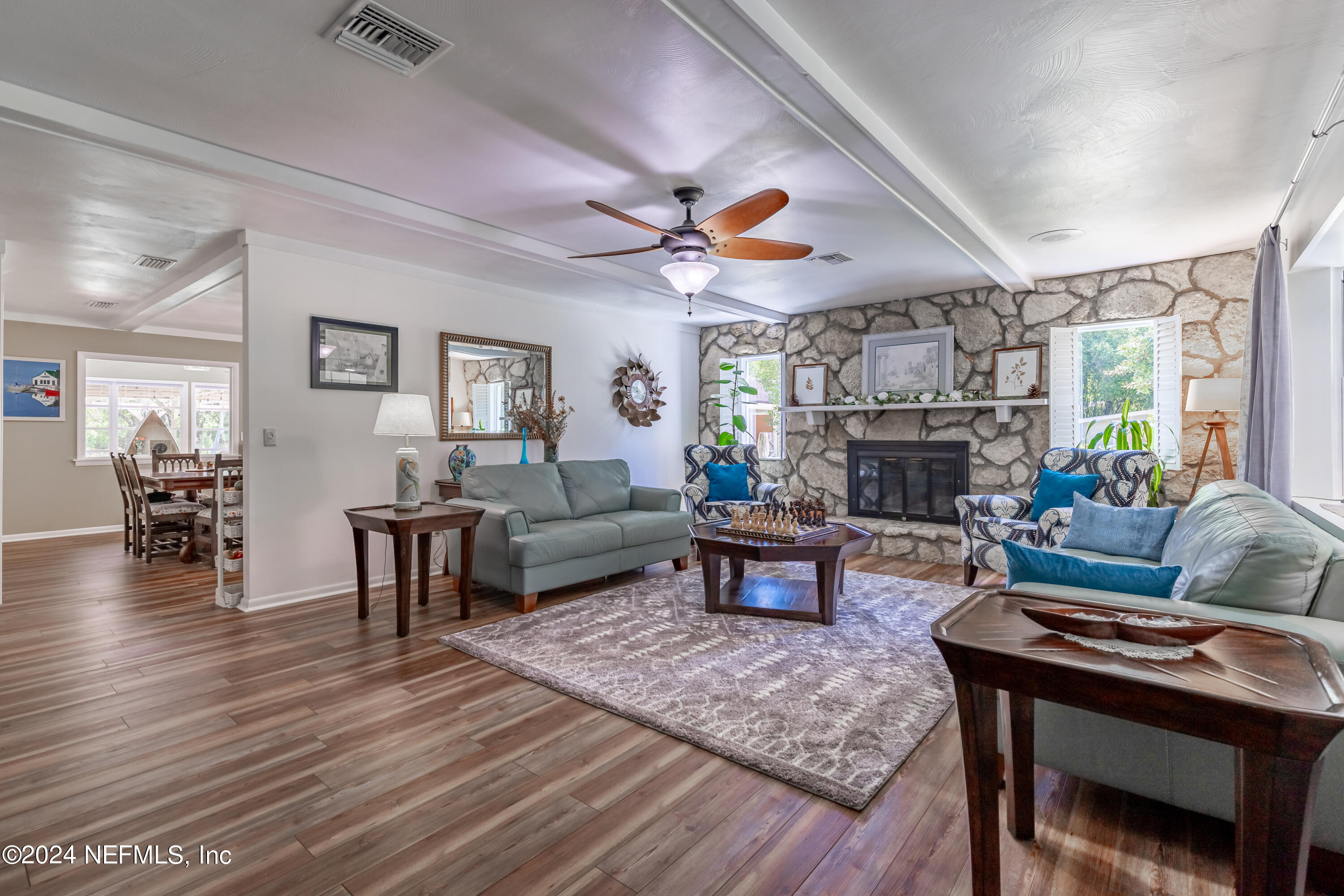 6070 Datil Pepper Road St. Augustine, FL 32086 - Photo 3 of 73 a living room with furniture a fireplace and a large window