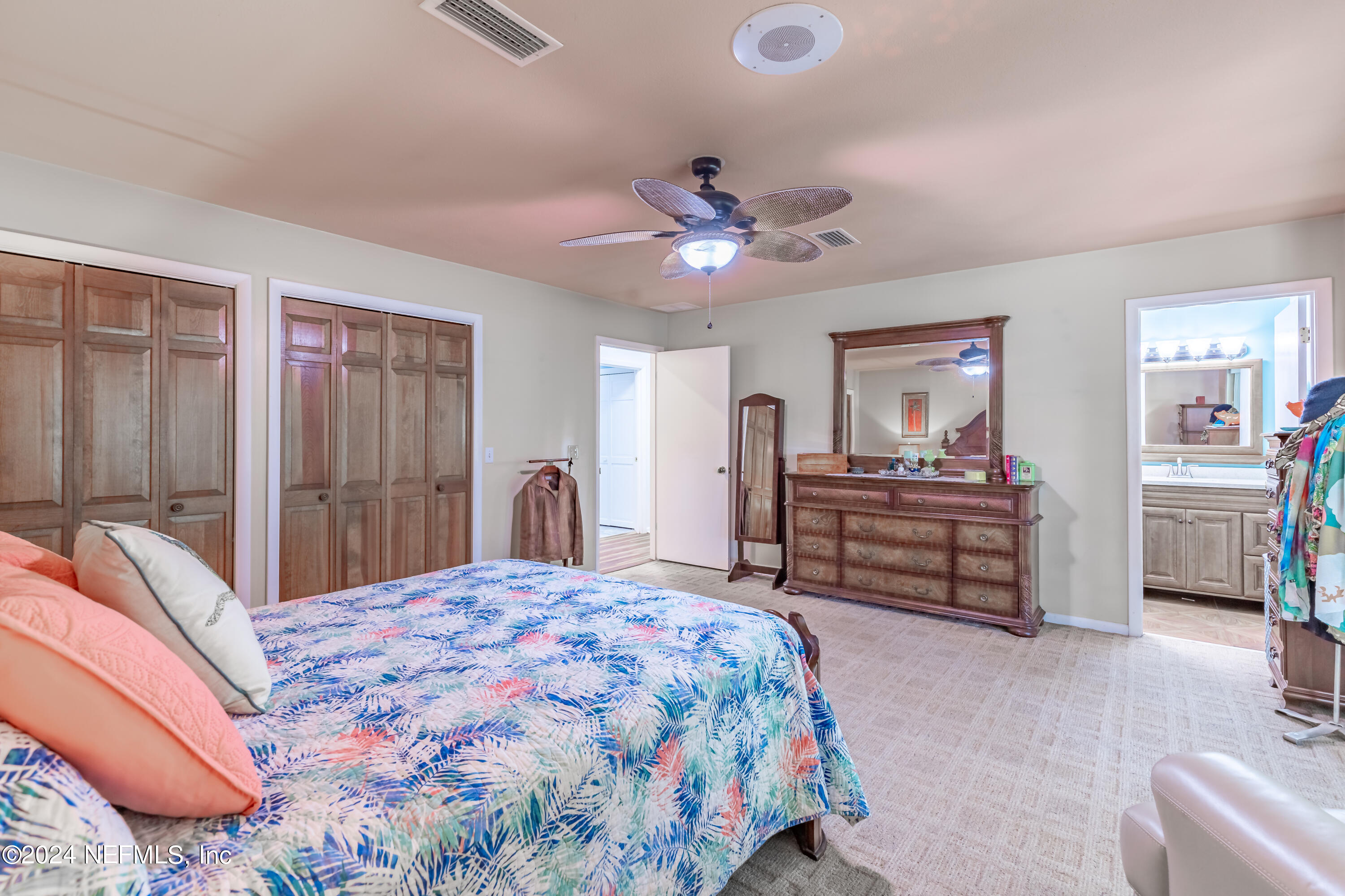 6070 Datil Pepper Road St. Augustine, FL 32086 - Photo 34 of 73 a bedroom with a bed and a chandelier