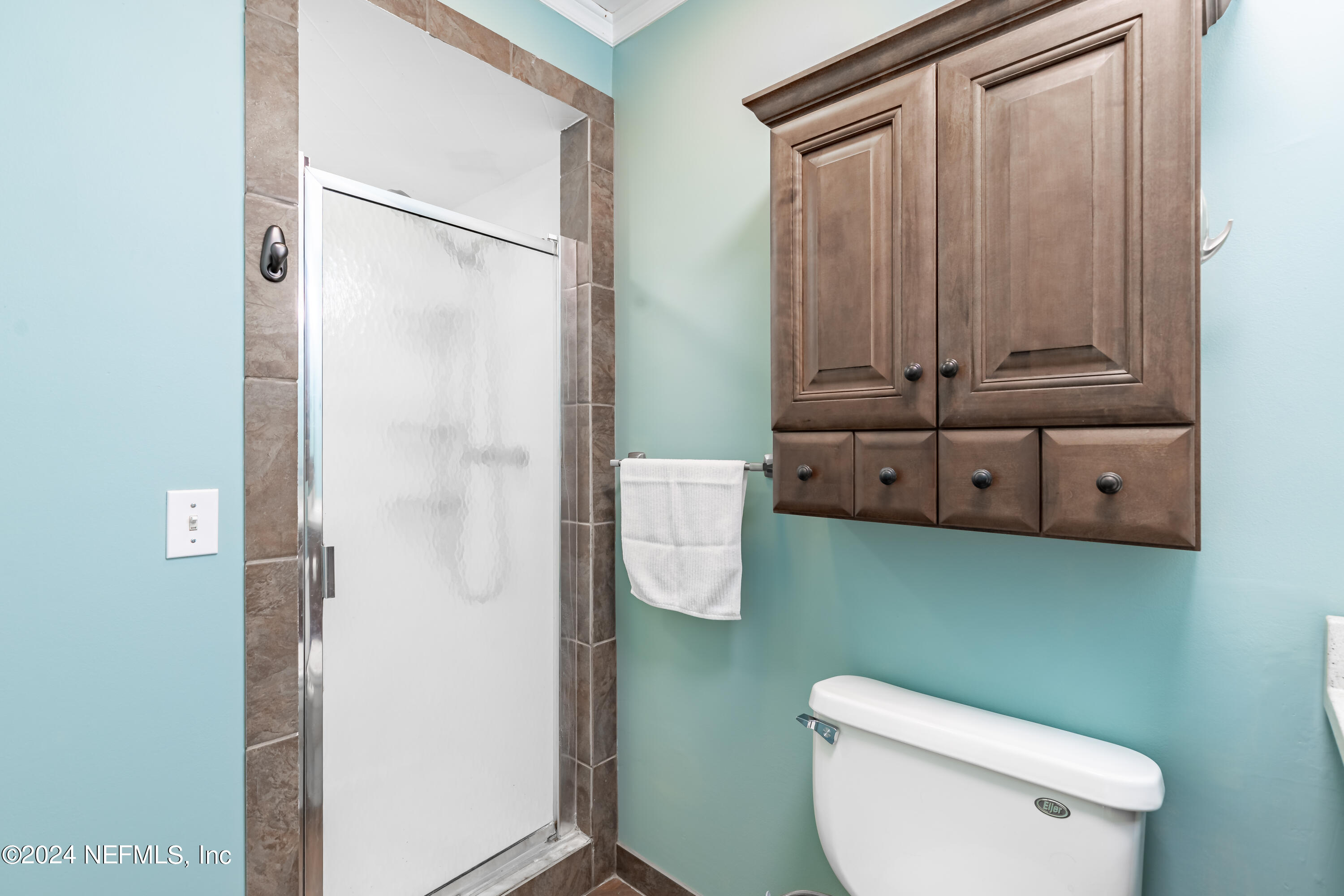 6070 Datil Pepper Road St. Augustine, FL 32086 - Photo 36 of 73 a bathroom with a toilet a sink and mirror