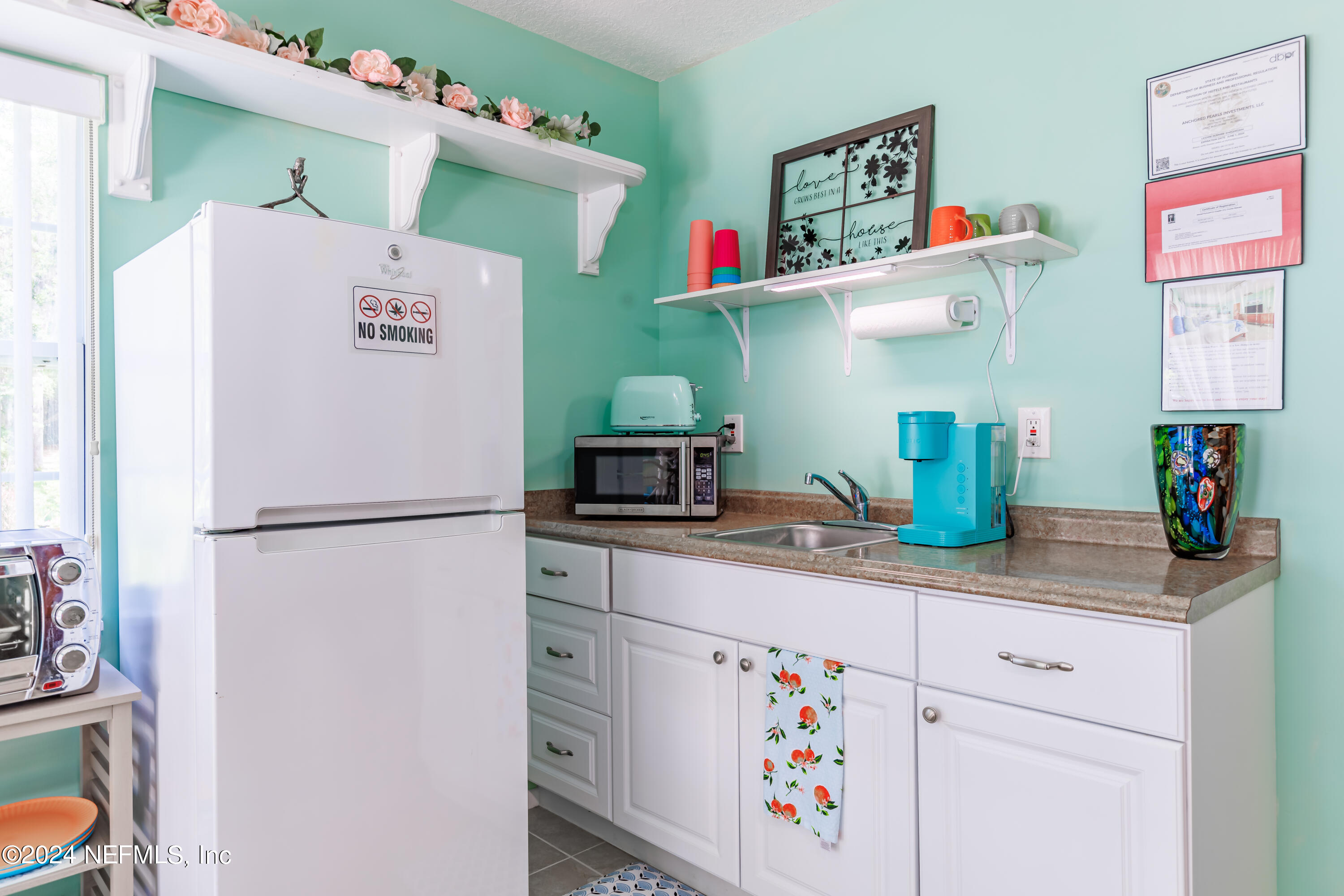 6070 Datil Pepper Road St. Augustine, FL 32086 - Photo 46 of 73 a white refrigerator freezer sitting inside of a kitchen
