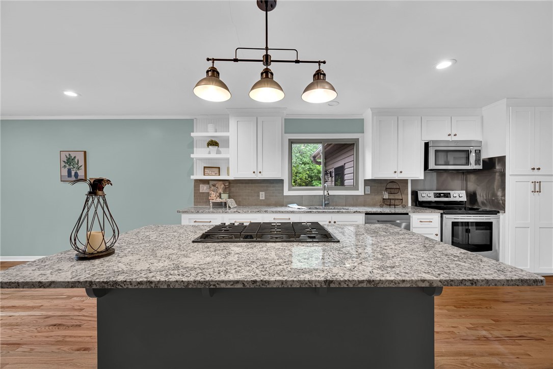 433 Latham Road Easley, SC 29640 - Photo 17 of 50 Culinary delights await in this bright kitchen with a spacious island and gleaming granite countertops.