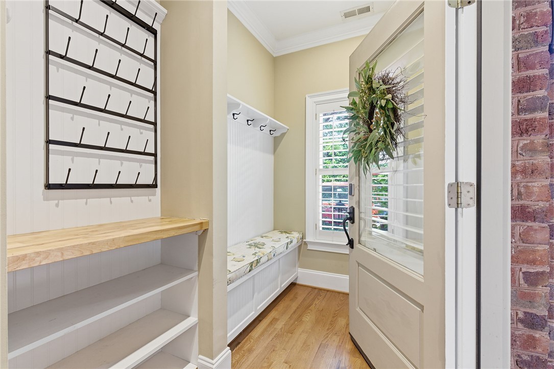 204 Butler Avenue Greenville, SC 29601 - Photo 3 of 26 A welcoming entryway with natural hardwood flooring and thoughtful built-in storage solutions.