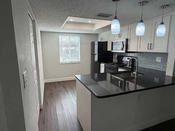 a kitchen with a sink stove and refrigerator
