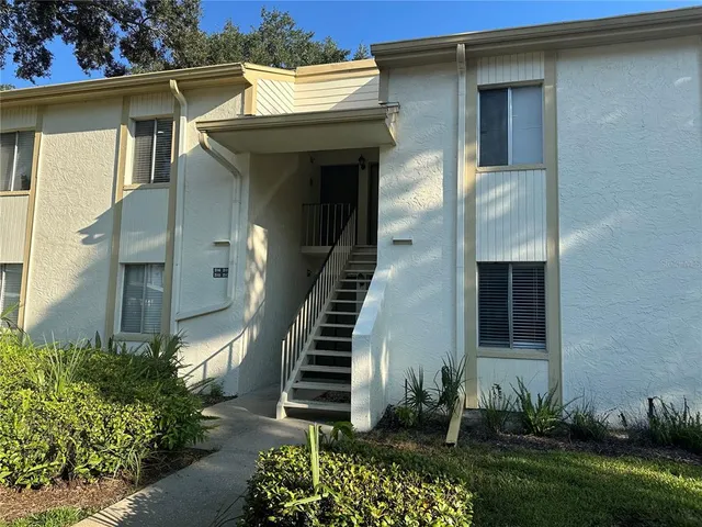 a view of a house with potted plants and a table