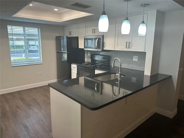a kitchen with a sink stove and refrigerator