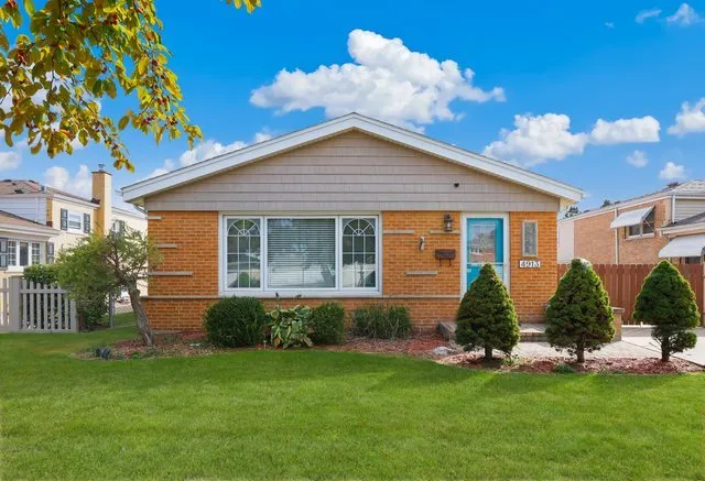a view of a house with a yard and a garden
