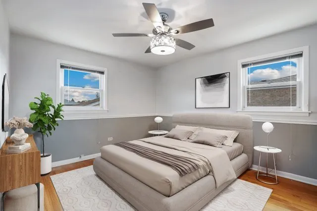 a bedroom with a large bed and a chandelier