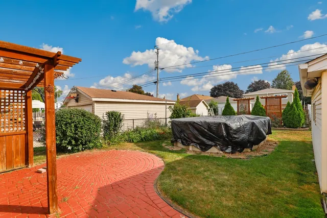 a backyard of a house with table and chairs