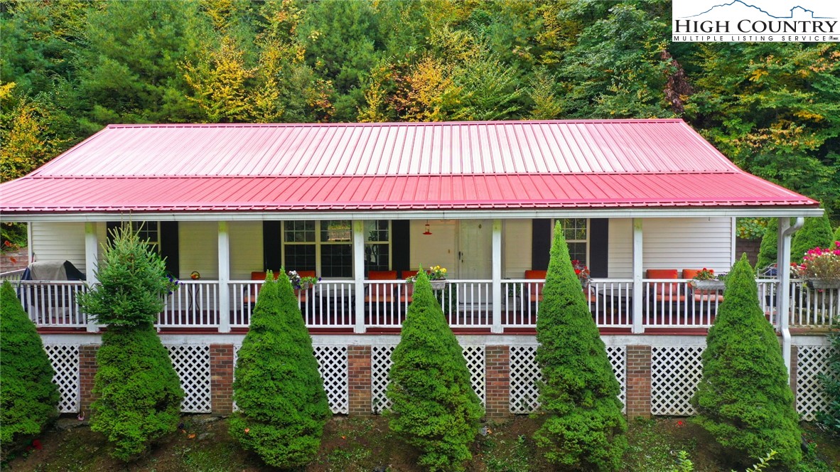 697 Jordan V Cook Road Boone, NC 28607 - Photo 1 of 3 a front view of a house with garden and porch