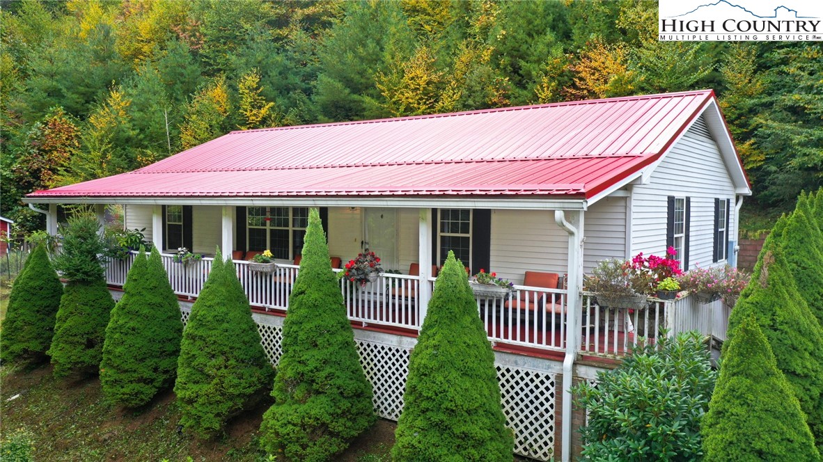 697 Jordan V Cook Road Boone, NC 28607 - Photo 2 of 3 a front view of a house with a garden and porch
