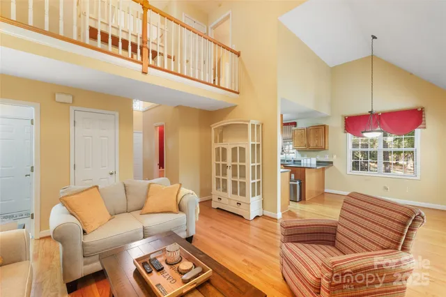 a living room with furniture a rug and a window